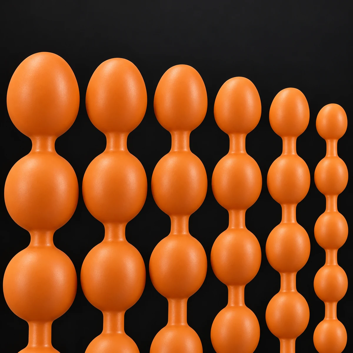 Copper Egg Beads lineup detail, six bead diameters with the strings continuing outside the frame